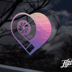 May include: A pink and purple heart-shaped decal with a stylised turbocharger design inside. The decal has a gradient effect and is on a black background. The text "The Electric Graphic Co." is in the bottom right corner.