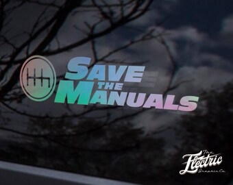 May include: A rainbow iridescent vinyl sticker with the text "Save the Manuals" and a gear shift pattern. The sticker is on a black car window.