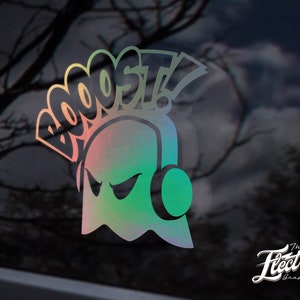 May include: A holographic sticker featuring a ghost wearing headphones with the word "BOOST!" above it. The sticker is on a black background.