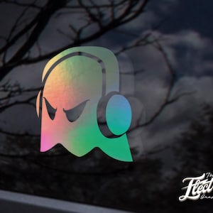 May include: A holographic sticker of a ghost wearing headphones. The ghost has a menacing expression with a green, blue, and pink colour scheme. The sticker is from The Electric Graphics Co.
