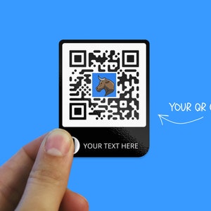 May include: Black and white QR code with a bull's head logo in a blue square. The text "YOUR QR CODE" is written in white above the code. The text "YOUR TEXT HERE" is written in white below the code.