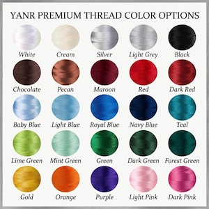 May include: A color chart titled YANR PREMIUM THREAD COLOR OPTIONS displaying twenty-five circular thread samples in various shades including white, cream, silver, light grey, black, chocolate, pecan, maroon, red, dark red, blue tones, and greens.