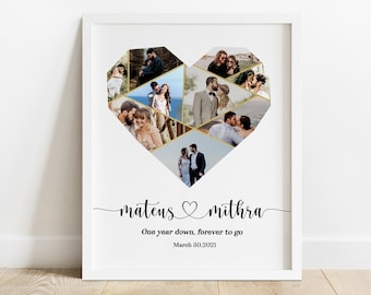 May include: A white framed print with a heart-shaped collage of photos of a couple. The heart is made of gold geometric shapes. The text "mateus ♥ mithra" is below the collage, followed by "One year down, forever to go" and "March 30, 2021".