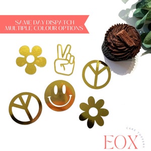 May include: Gold peace sign, flower, smiley face, and peace sign cake toppers.  The toppers are on a white background.  The text "SAME DAY DISPATCH MULTIPLE COLOUR OPTIONS" is at the top of the image.