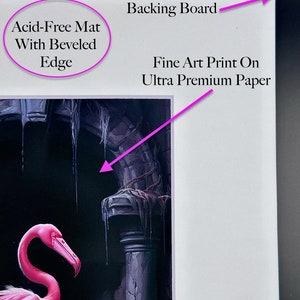 May include: A fine art print on ultra premium paper, featuring a pink flamingo standing in a dark, gothic setting. The print is mounted on an acid-free mat with a beveled edge and backed by a white board.