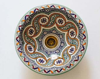 May include: A white ceramic sink with a colorful Moroccan-inspired design. The sink features intricate blue, green, orange, and red patterns.