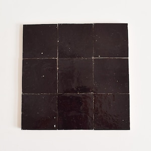 May include: Nine dark brown square tiles arranged in a 3x3 grid.