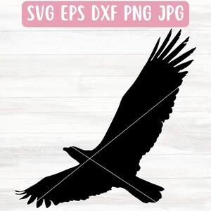 May include: Black silhouette of an eagle with wings spread wide, flying against a white woodgrain background.