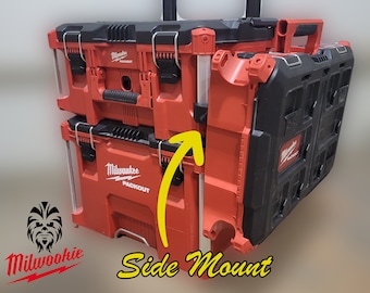 May include: Two red Milwaukee Packout tool boxes stacked on top of each other. The boxes are mounted to a wall using a side mount system. The side mount system is made of metal and has a silver finish.