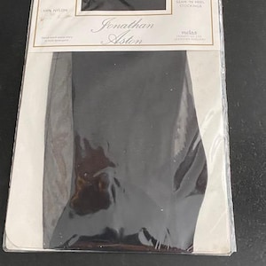 May include: A pair of black ultra sheer stretch seam 'n heel stockings by Jonathan Aston in original packaging. The white cardboard header features the brand name, 100% nylon material composition, size XS, and the text Ultra Sheer Stretch Seam 'N Heel Stockings.
