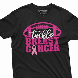 May include: Black t-shirt with a pink football graphic and the text "Tackle Breast Cancer" with a pink ribbon.