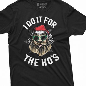 May include: Black t-shirt with a white graphic of Santa Claus wearing sunglasses and a beard. The text "I do it for the ho's" is printed below the image.
