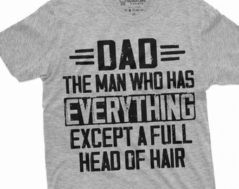 May include: Gray t-shirt with a black graphic that reads "=DAD= The man who has EVERYTHING EXCEPT A FULL HEAD OF HAIR"