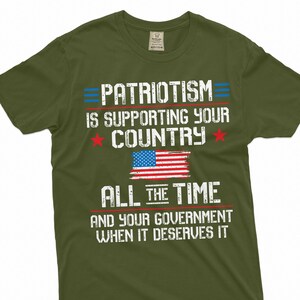 May include: Green t-shirt with a distressed white graphic that reads "PATRIOTISM IS SUPPORTING YOUR COUNTRY ALL THE TIME AND YOUR GOVERNMENT WHEN IT DESERVES IT". The graphic also includes a red, white, and blue American flag.