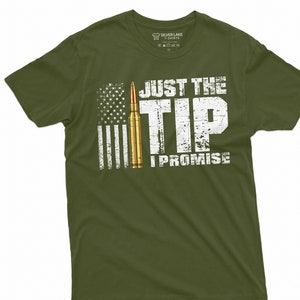 May include: A green t-shirt with a distressed white graphic of an American flag, a bullet, and the text "Just the Tip I Promise".