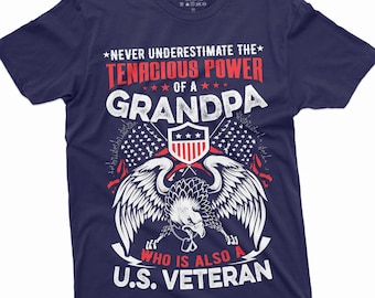 May include: Navy blue t-shirt featuring a white eagle graphic and the text "Never underestimate the tenacious power of a grandpa who is also a U.S. Veteran".