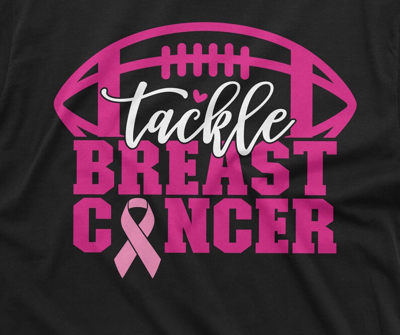 May include: Pink and white graphic on a black t-shirt with a football and the text "Tackle Breast Cancer".