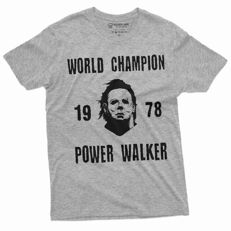May include: A grey t-shirt with a black graphic print of a character from the film Halloween. The graphic includes the text "WORLD CHAMPION 19 78 POWER WALKER".