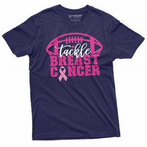 May include: Navy blue t-shirt with a pink football graphic and the text "tackle breast cancer" with a pink ribbon.