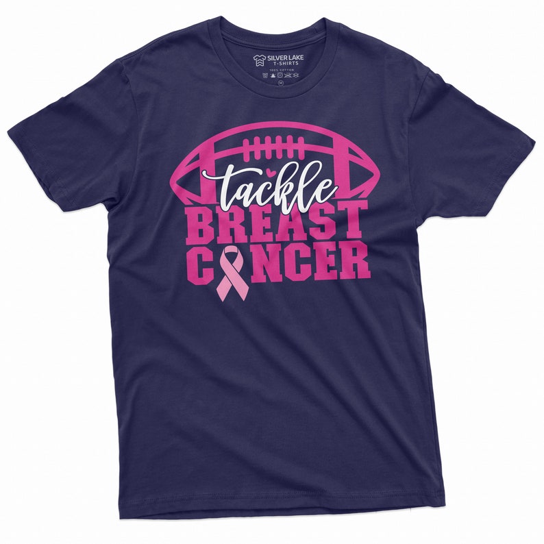May include: Navy blue t-shirt with a pink football graphic and the text "tackle breast cancer" with a pink ribbon.