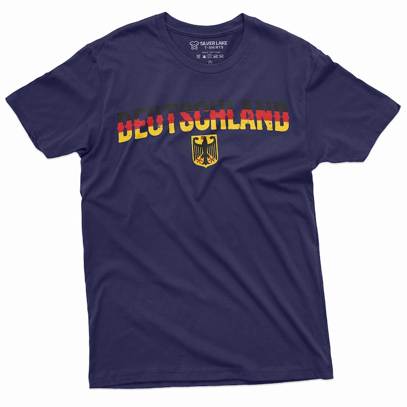 May include: A navy blue t-shirt with a distressed German flag design and the word "DEUTSCHLAND" printed in yellow, red, and black. The German eagle crest is centered below the text.