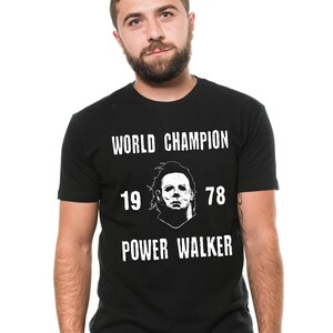 May include: Black t-shirt with a white graphic of a character from the movie Halloween. The graphic includes the text "World Champion", "19 78", and "Power Walker".