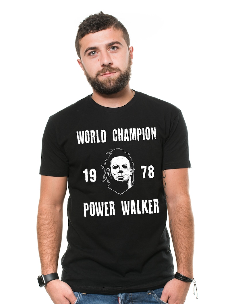 May include: Black t-shirt with a white graphic of a character from the movie Halloween. The graphic includes the text "World Champion", "19 78", and "Power Walker".