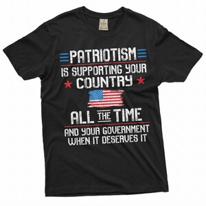 May include: Black t-shirt with a distressed graphic design that reads "PATRIOTISM is supporting your COUNTRY ALL THE TIME and your government when it deserves it". The graphic also includes a red, white, and blue American flag.