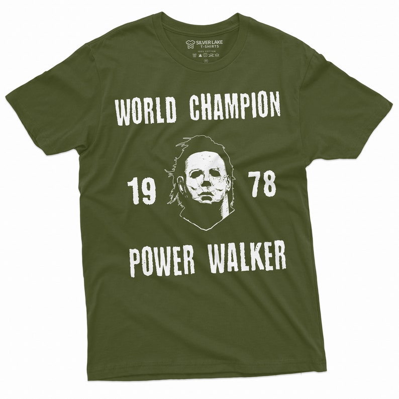 May include: A green t-shirt with a white graphic of a horror movie character's mask. The text "WORLD CHAMPION 19 78 POWER WALKER" is printed on the shirt.