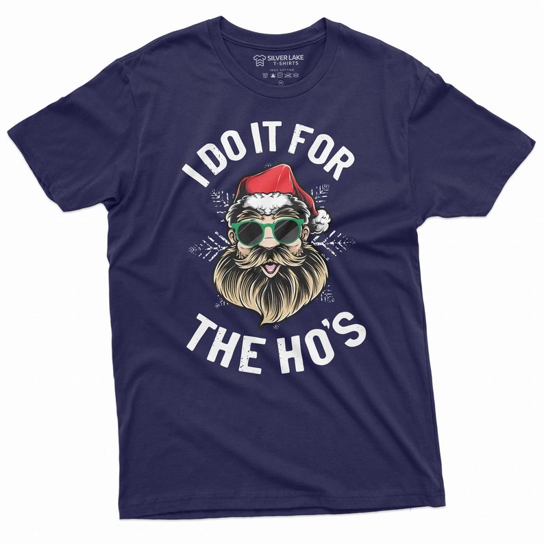 May include: A navy blue t-shirt with a white graphic of Santa Claus wearing sunglasses and a beard. The text "I do it for the ho's" is printed in white below the graphic.