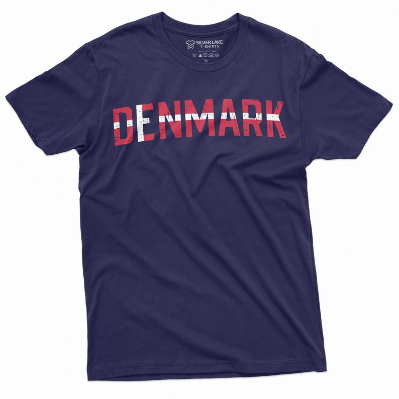 May include: A navy blue t-shirt with the word "DENMARK" printed in white letters with a red and white flag design.