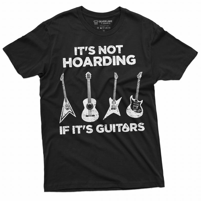 May include: Black t-shirt with white text that reads "It's not hoarding if it's guitars". The shirt features a graphic of five guitars, including an acoustic guitar, an electric guitar, and three other guitars.