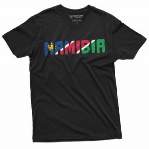 May include: Black t-shirt with the word "NAMIBIA" written in large, colorful letters. Each letter is colored in the colors of the Namibian flag.