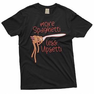 May include: Black t-shirt with a red and yellow illustration of spaghetti on a fork. The text "more spaghetti less upsetti" is printed on the shirt.