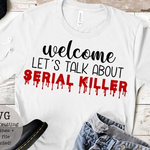 May include: White t-shirt with black text that reads "welcome let's talk about serial killer" with red dripping paint.