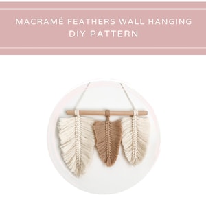 May include: Macrame feather wall hanging DIY pattern. Three macrame feathers, one brown and two white, hang from a wooden dowel.