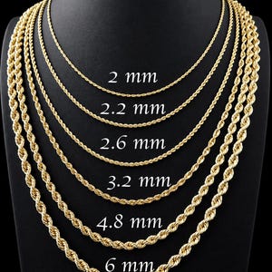 May include: A display of gold-colored rope chains of varying thicknesses, from 2 mm to 6 mm, against a black background. Each chain is labeled with its size in millimeters, showcasing the different chain styles available.