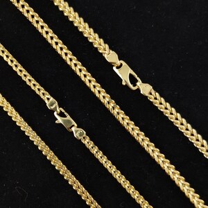 May include: Four gold chains of different lengths, all with a wheat chain pattern.