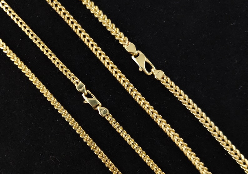 May include: Four gold chains of different lengths, all with a wheat chain pattern.