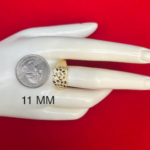 May include: A gold signet ring with a textured surface. The ring is 11 mm wide.