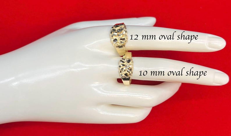 May include: Two gold rings with a textured surface. The ring on the left is 12 mm oval shape and the ring on the right is 10 mm oval shape.