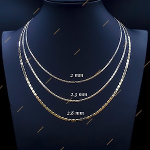May include: Three gold chains of different widths, 2 mm, 2.3 mm, and 2.8 mm, displayed on a black mannequin.