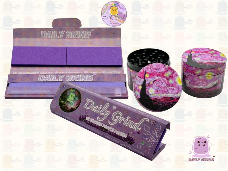 A dark Purple packet and a Green box with the text 'Daily Grind' on both and ‘Kingsize Purple Papers' on one and ‘Kingsize Green Papers’ on the other. Both boxes open showing green papers in one and purple in the other. There is a tobacco grinder with a classic pink piece of art underneath it and The 'Daily Grind' logo is in the corner of the image