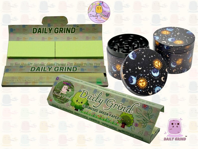 A dark Purple packet and a Green box with the text 'Daily Grind' on both and ‘Kingsize Purple Papers' on one and ‘Kingsize Green Papers’ on the other. Both boxes open showing green papers in one and purple in the other. There is a tobacco grinder with a cartoon sun and moon astrology design on it underneath it and The 'Daily Grind' logo is in the corner of the image