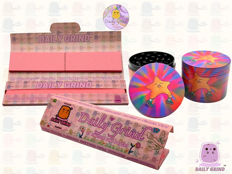 A pink and white box with the text 'Daily Grind' and ‘Kingsize Pink Papers' on it. The box is open and there are Pink papers inside. There is a tobacco grinder with a very happy and confident star character in the middle with rays of light behind him next to the box and The 'Daily Grind' logo is in the corner of the image