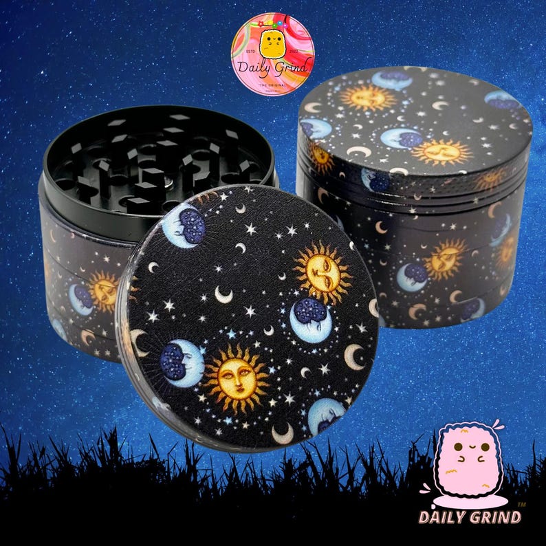 A four piece Metal Tobacco Grinder with a spiritual astrology design. The grinder features a cartoon sun & moon in a dark night sky full of stars. The inside of the grinder is black. The background of the image is a dark night sky and The Daily Grind logo is visible in the corner of the image