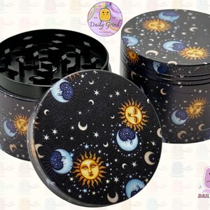 A four piece Metal Tobacco Grinder with a spiritual astrology design. The grinder features a cartoon sun & moon in a dark night sky full of stars . The inside of the grinder is black. The Daily Grind logo is visible in the corner of the image