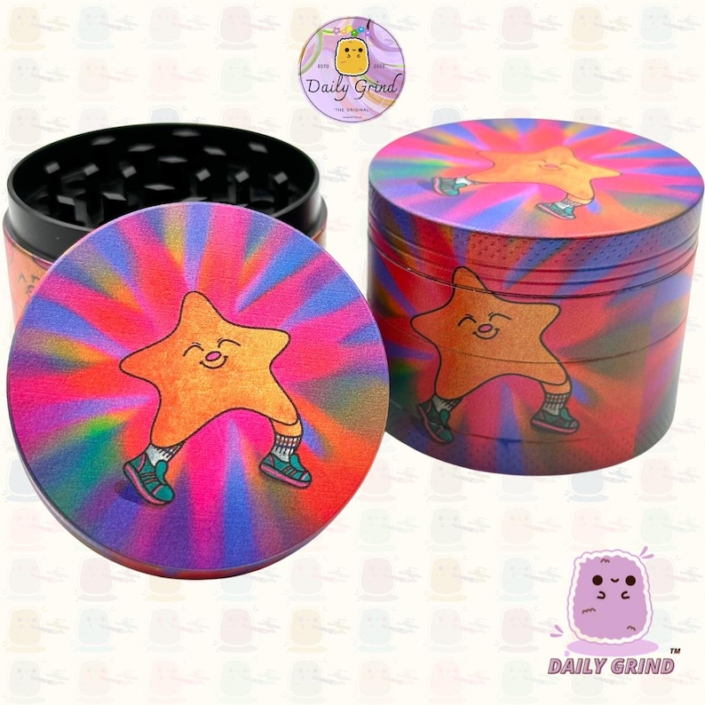 A four piece Metal Tobacco Grinder with a colourful striking design. The grinder features a star very happy in the middle of the image with a multi coloured explosion behind him. The inside of the grinder is black. The Daily Grind logo is visible in the corner of the image