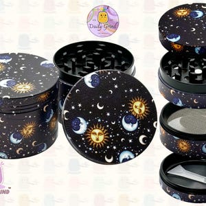 A four piece Metal Tobacco Grinder with a spiritual astrology design disassembled and showing all the different layers, the top two contain the grinding teeth and the bottom two are for storage. The grinder features a cartoon sun & moon in a dark night sky full of stars . The inside of the grinder is black. The Daily Grind logo is visible in the corner of the image