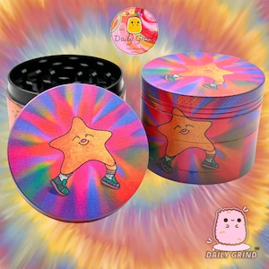 A four piece Metal Tobacco Grinder with a colourful striking design. The grinder features a star very happy in the middle of the image with a multi coloured explosion behind him. The inside of the grinder is black. The background of the image is dark green and The Daily Grind logo is visible in the corner of the image